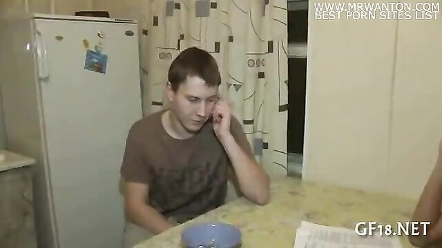 Young amateur guy in kitchen on phone, casual homemade thumbnail