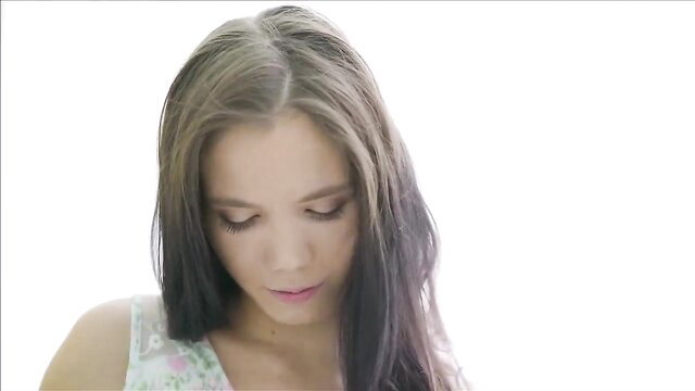 Small tits teen with long brown hair looks seductive in tank top