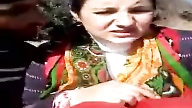 Woman outdoors, possibly with another person