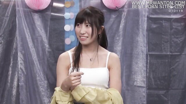 Young Asian model pointing at the camera with a slight smile