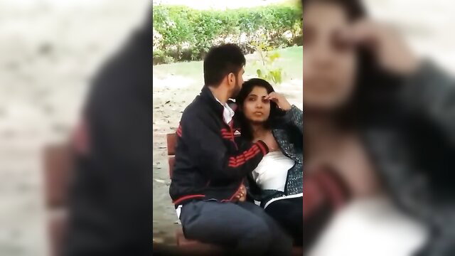 Lewd amateur Indian couple cuddling intimately on park bench