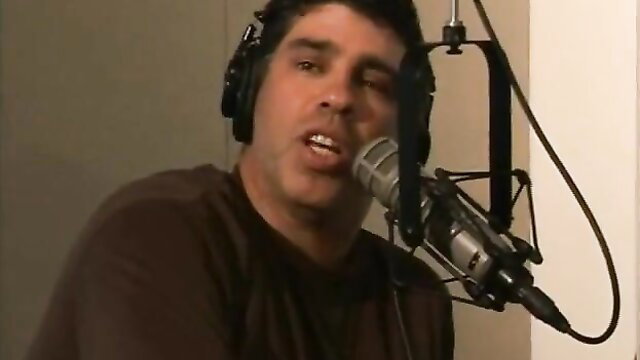 Nicole Sheridan in studio interview with headphones and mic