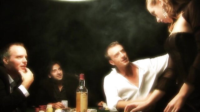 Blonde woman in sexy black dress at poker table with 4 men