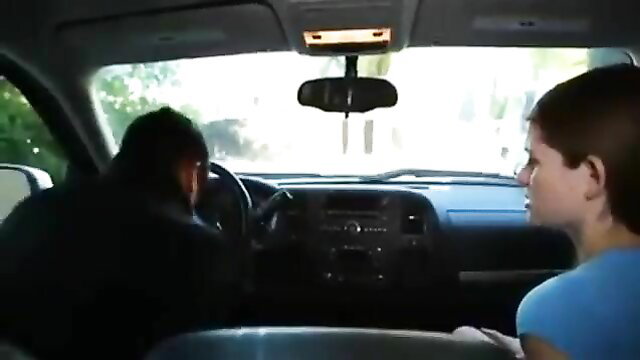 Young redhead teen girl in car with black man driver, close talk