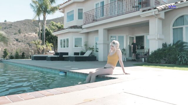 Blonde Scarlett Hampton in yellow bikini by pool at luxury home