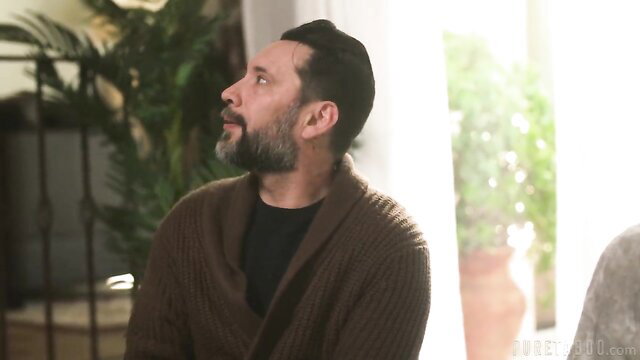 Avery Jane's handsome male neighbor in cozy sweater gazes intently