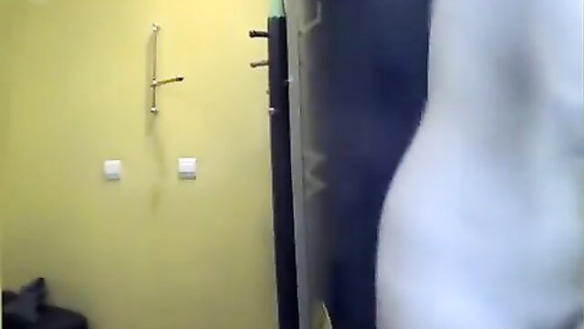 Nude woman with small tits bending over in tanning room