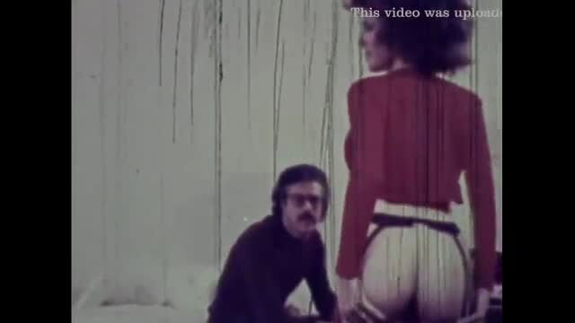 Vintage brunette with big ass in garter belt, guy kneeling behind in classic porn scene